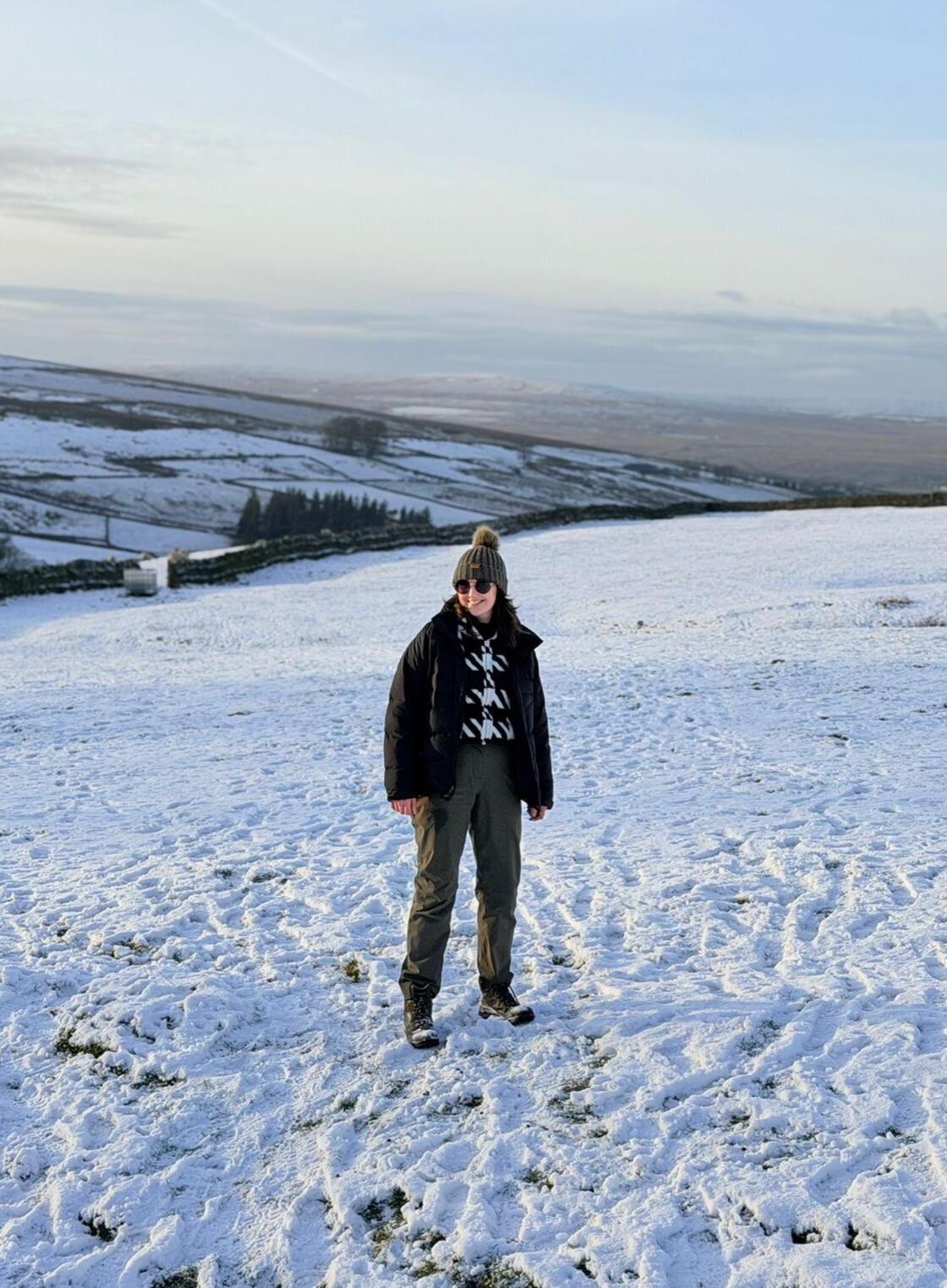 A person stood in a snowy landscape